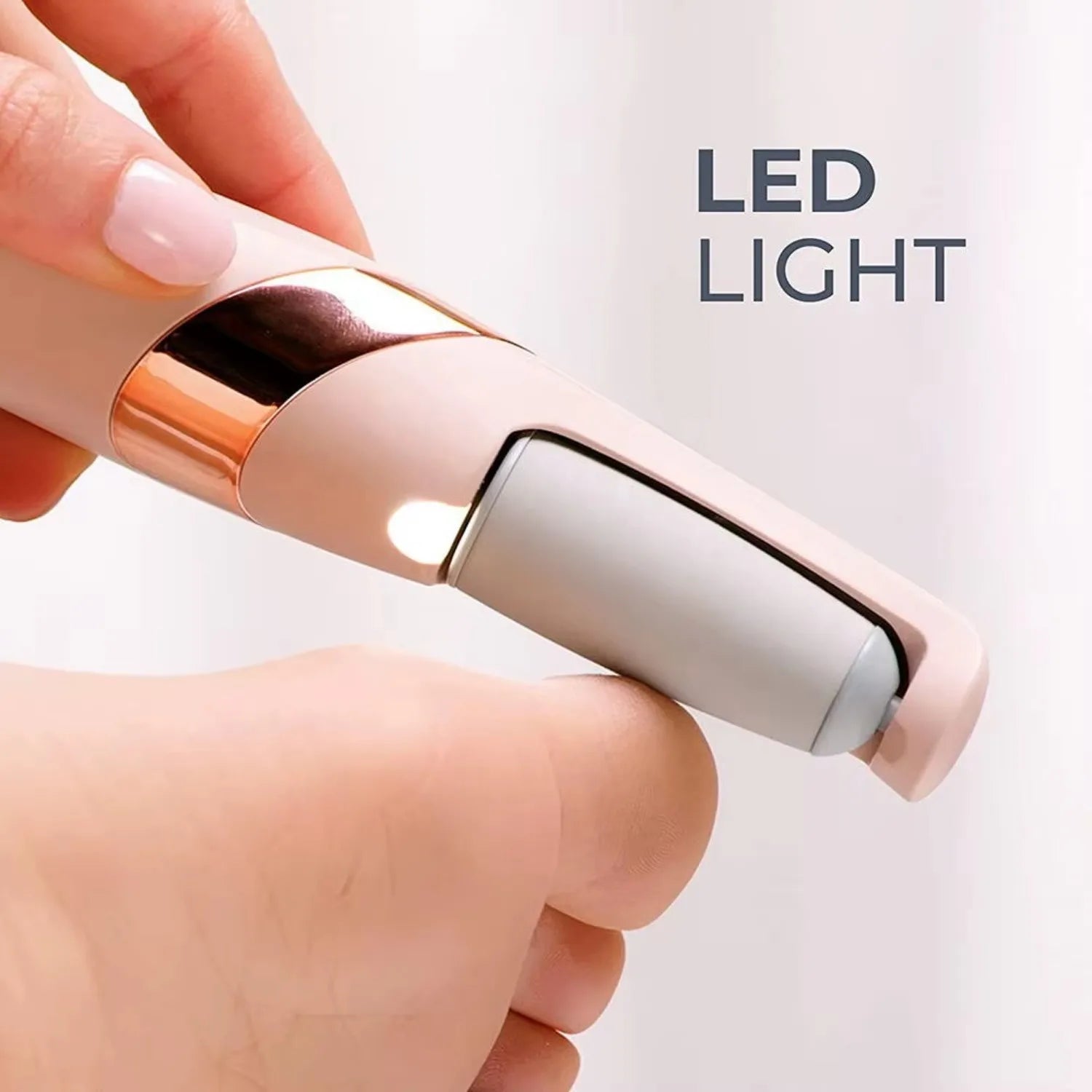 Hand holding an electric callus remover with 'LED LIGHT' text on a white background