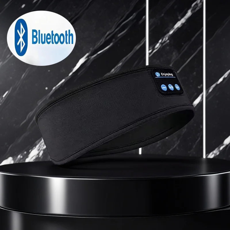 Black Bluetooth headband on a black platform with a marble background