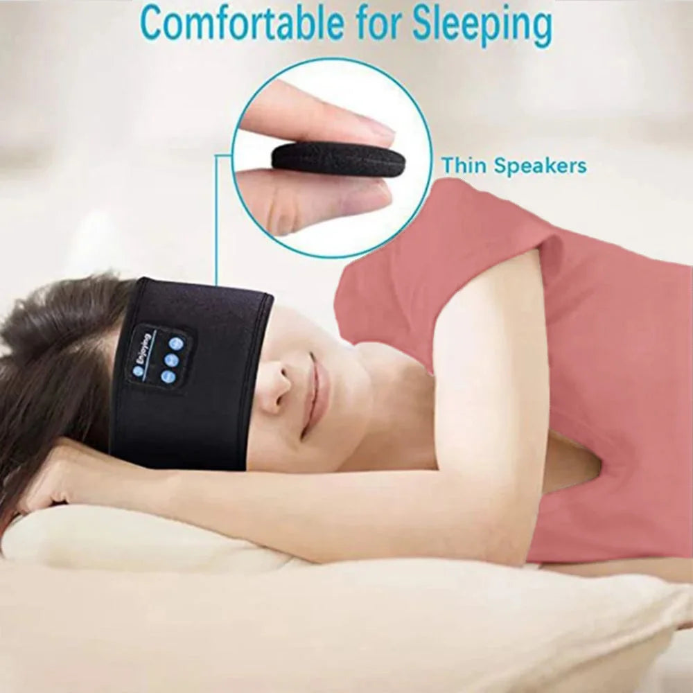 Person wearing a black sleep mask with thin speakers, lying down and sleeping.
