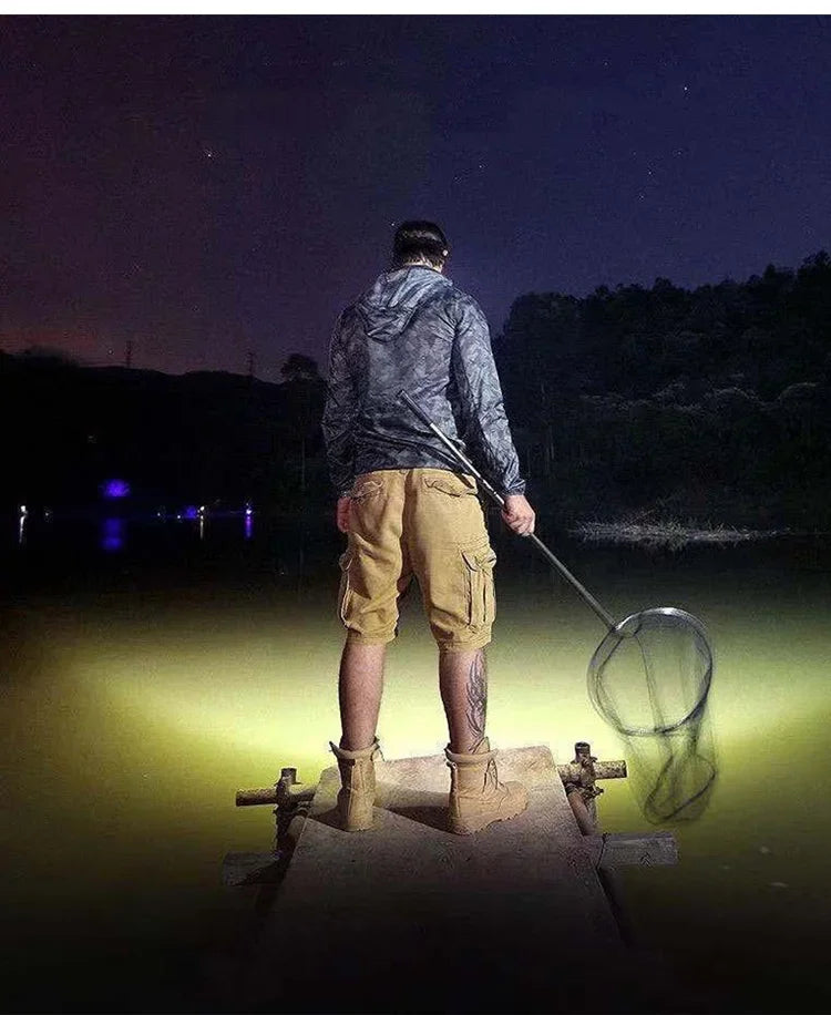 Headlamp worn by person fishing at night with a net on a dock